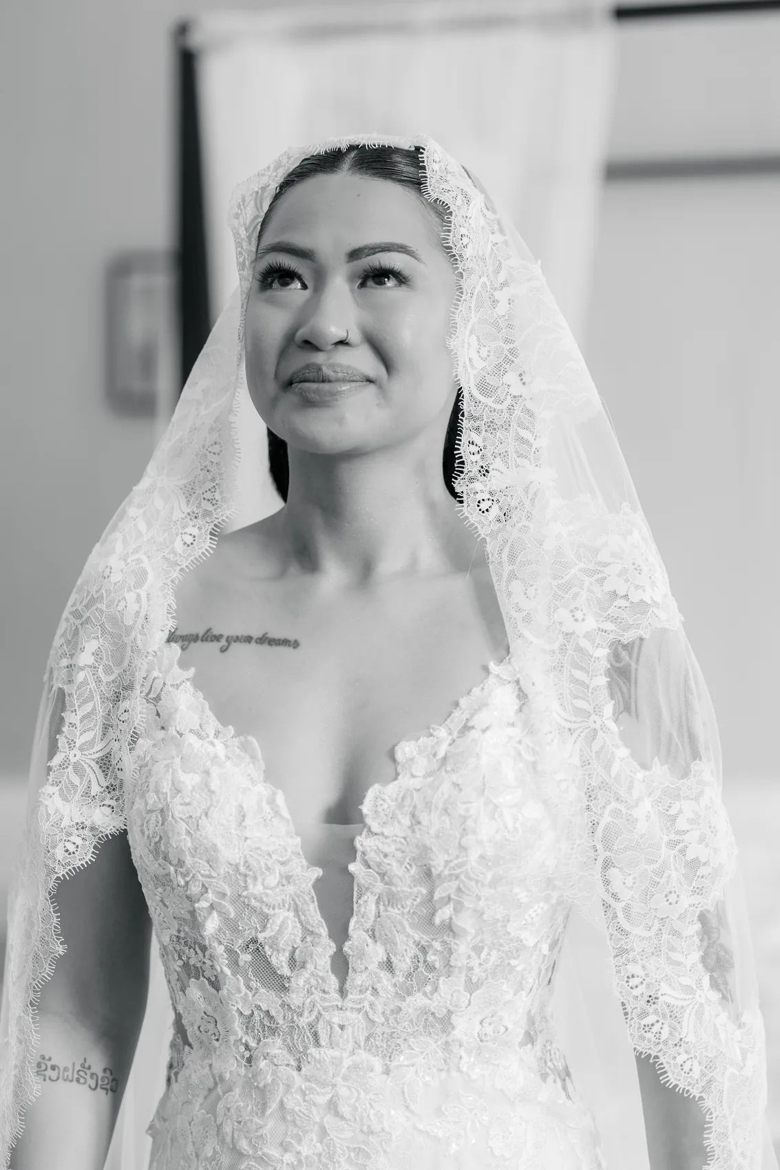 Portrait de la mariée sous son voile, en noir et blanc
